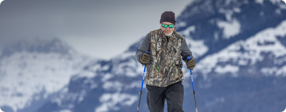 Man skiing with mountains in the background