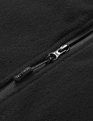 Black fleece vest close-up showing the zipper pull and textured fabric