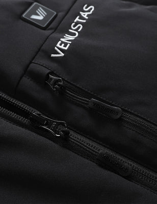 Close-up of black heated golf vest showing chest logo, zip pocket, and front zipper