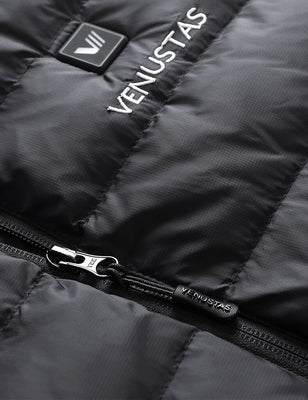 Close-up of black heated vest showing zipper pull, logo embroidery, and power button