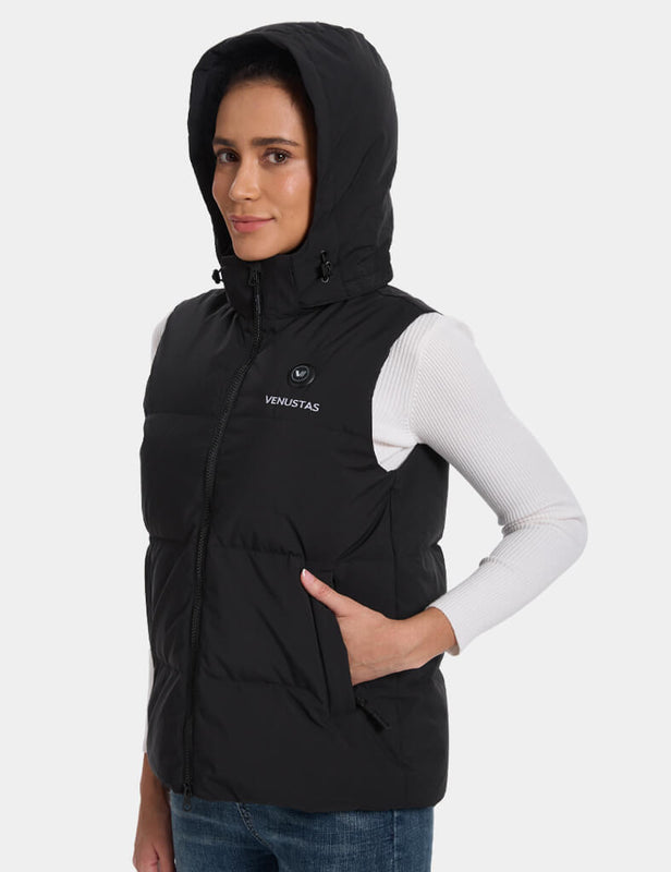 Side view of a black hooded heated vest with the hand pocket in use