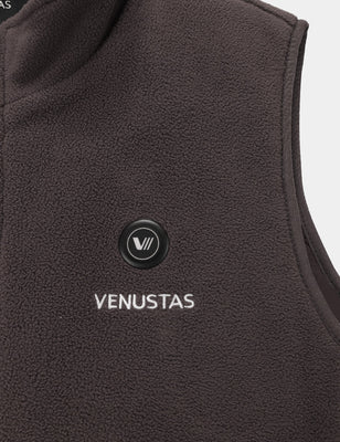 Close-up of the brown fleece heated vest chest area with round control button