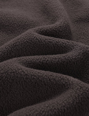 Close-up of the brown fleece fabric texture with soft folds