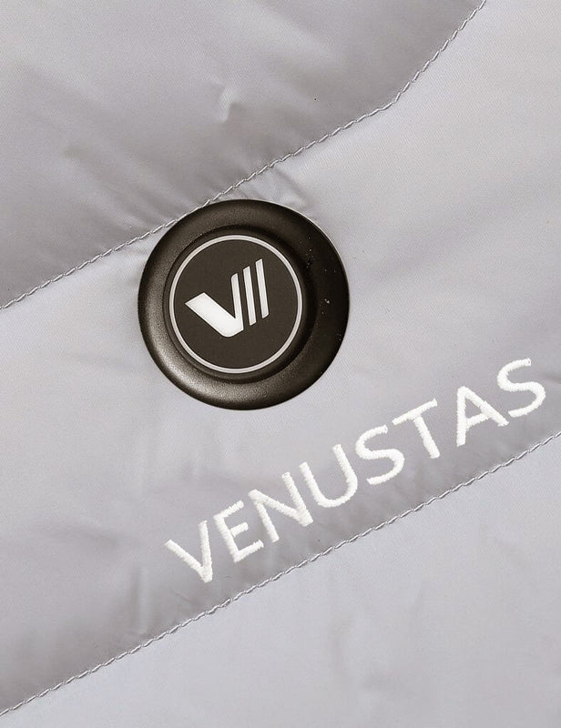 Close-up of the power button on a light gray heated jacket