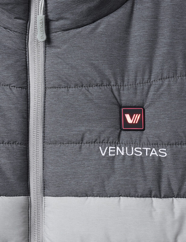 Gray heated vest chest detail with illuminated power button, logo, and front zipper