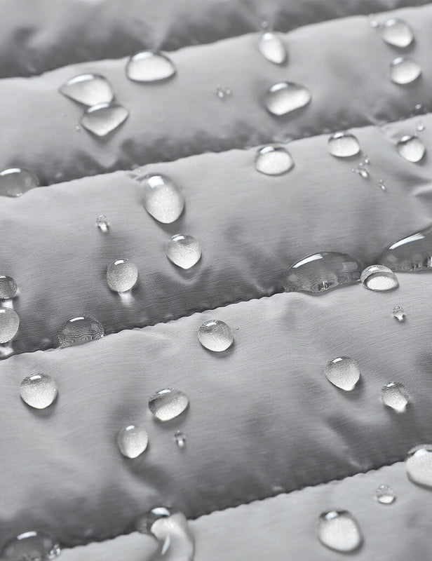 Water droplets beading on the gray quilted heated vest fabric