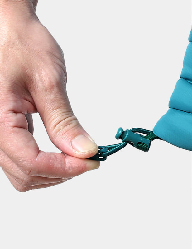 Hand adjusting the hem drawcord on a teal heated vest
