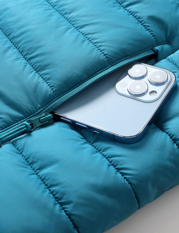 Teal heated vest zip pocket holding a smartphone