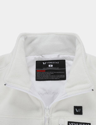 Close-up of the white fleece vest collar, zipper, and inside label