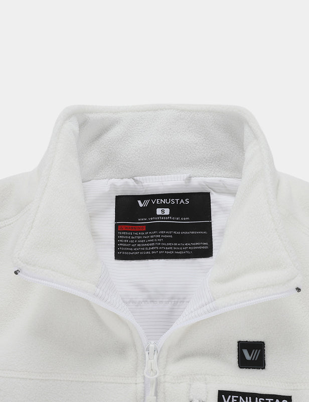 Close-up of the white fleece vest collar, zipper, and inside label